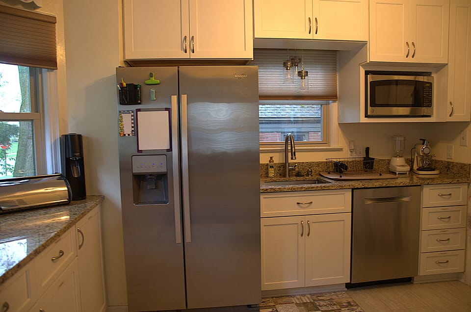 Refrigerator, microwave, and dishwasher in the kitchen area.
