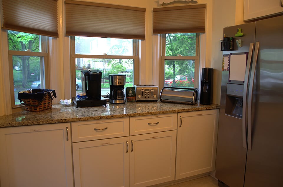 Kitchen bay window area with both a Keurig and a coffee pot available.