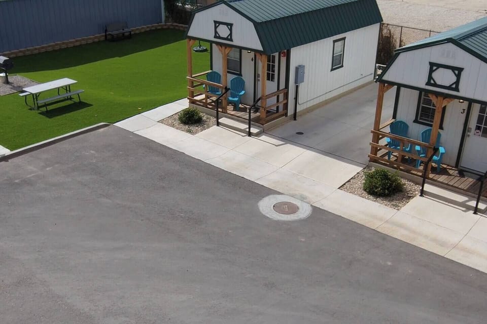 The turf area with charcoal bbq grill and picnic table