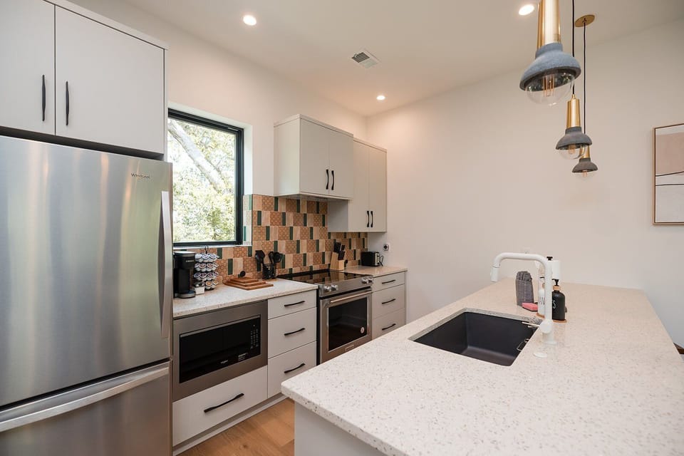 Chef-inspired kitchen featuring top-of-the-line KitchenAid appliances, quartz countertops, and everything needed for cooking and entertaining.