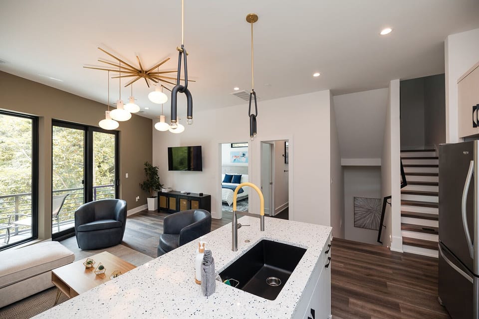 Spacious kitchen island and dining area provide the perfect gathering place for family meals, cocktails, and conversation.