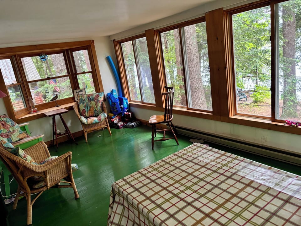 Enclosed sunroom facing the lake. Full picnic table for dining.