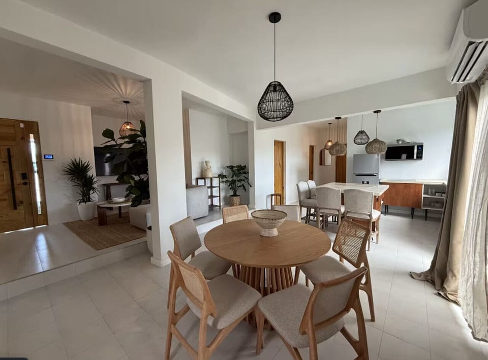 Spacious dining area with two dining tables, offering comfortable seating for larger groups