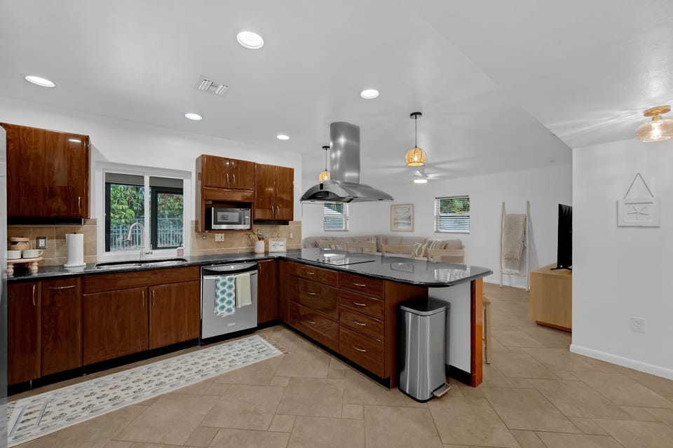 Kitchen with island cook top eat up area