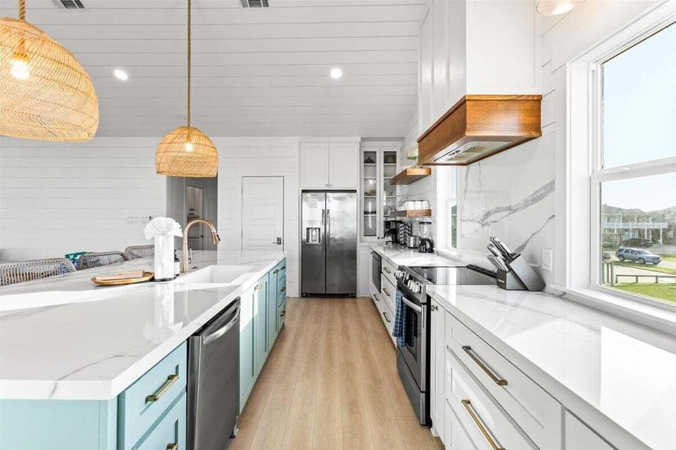 Galley-style kitchen with stainless refrigerator, oven, and ample counter space