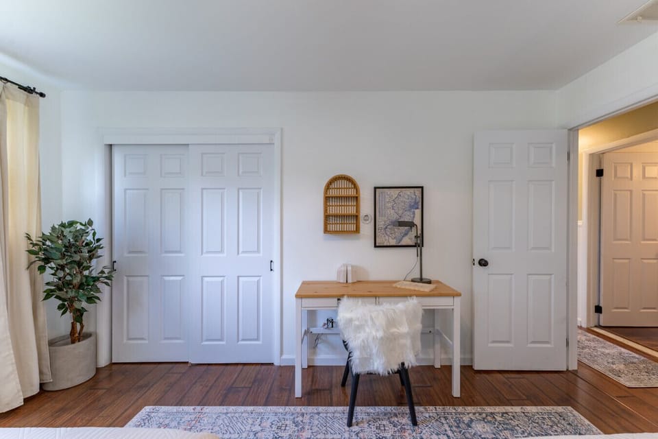 Inviting, well-lit room with a stylish desk setup and warm, modern decor for a relaxing getaway