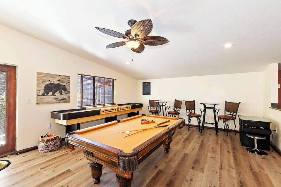 Game room with shuffle board, billiards and video game.