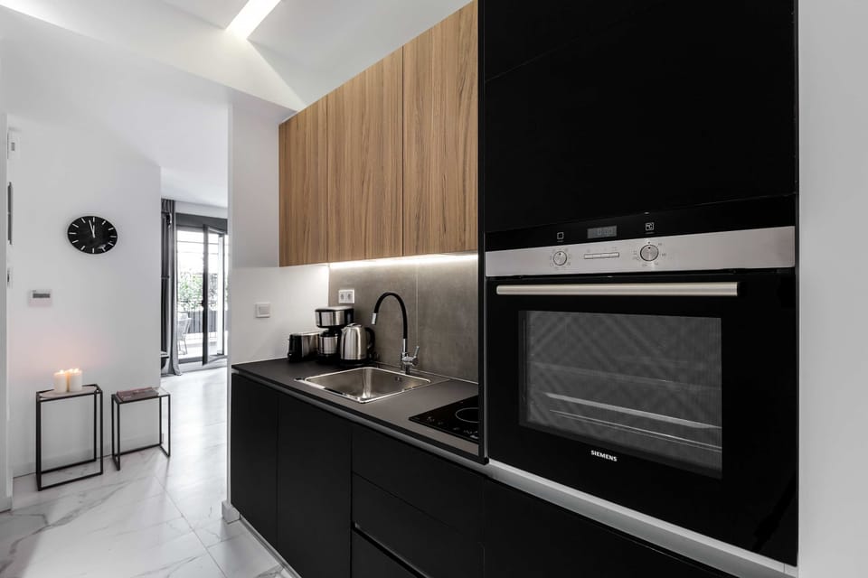 Sleek modern kitchen with built-in appliances makes preparing meals simple and enjoyable daily.