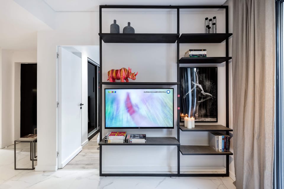 Smart entertainment wall with integrated shelving keeps the living area sleek and clutter-free.