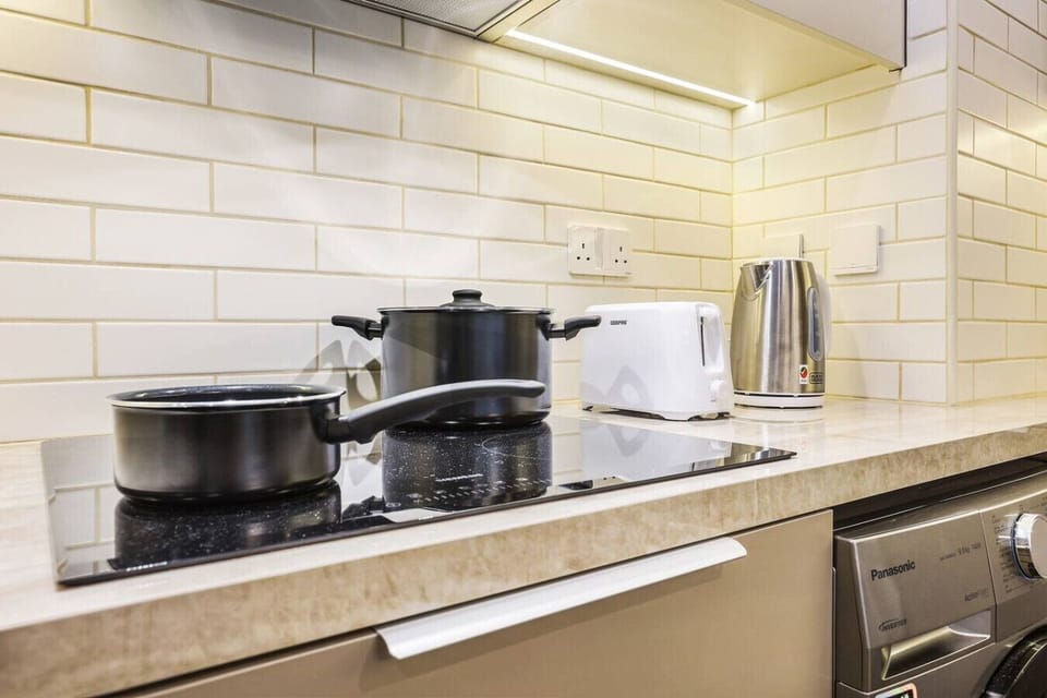 Kitchen: Whip up culinary delights in this sleek, modern space with top-notch appliances!