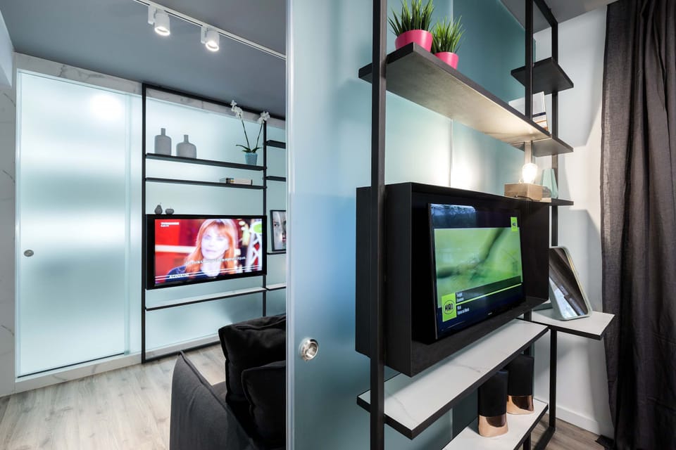 Smart open shelving and TV setup blend storage, entertainment, and polished contemporary design beautifully.