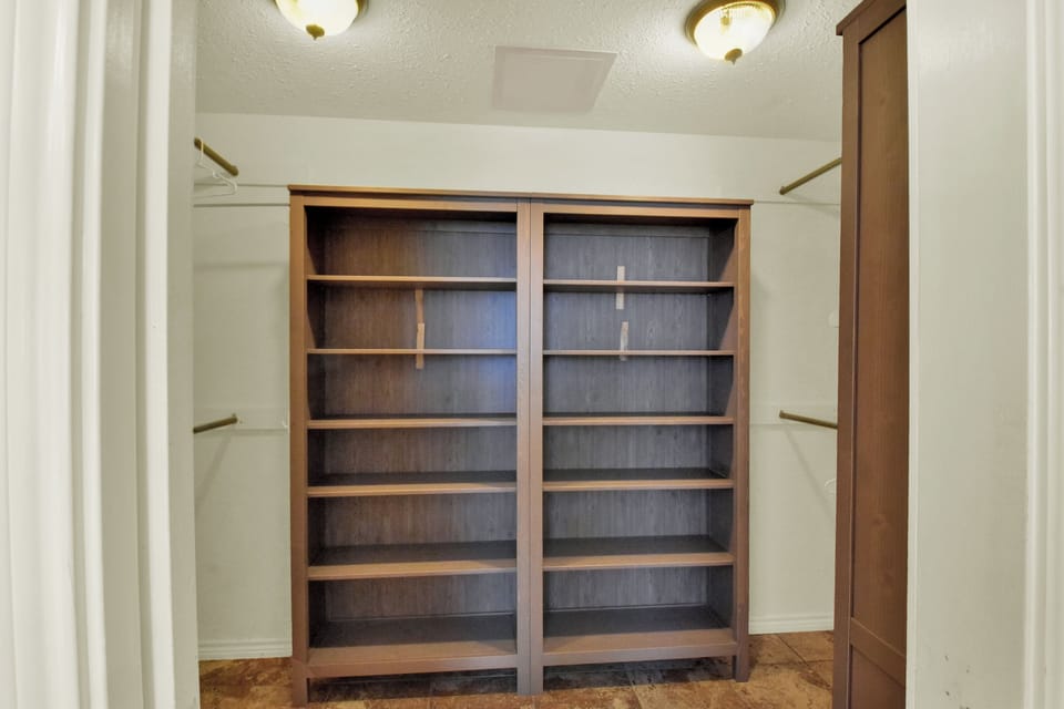 Primary bedroom walk in closet.