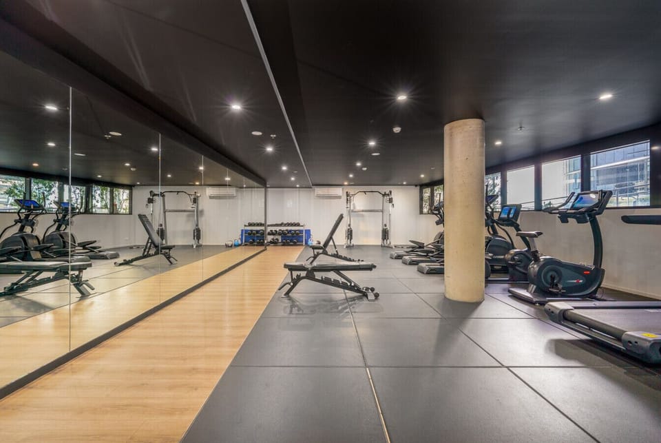 On-site fitness centre featuring modern equipment for cardio, strength, and flexibility training.