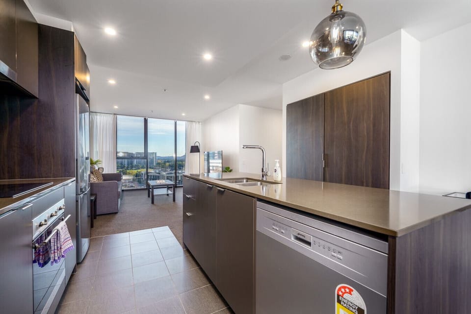 Neat and modern kitchen setup with everything you need within reach, from cookware to cutlery.
