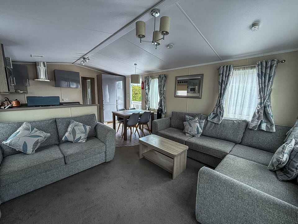 The open living area is perfect for hosting dinner parties or relaxing with loved ones in the static caravan.