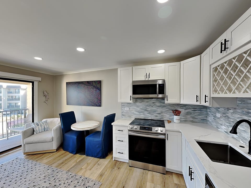 To your left from the entrance, a fully-equipped kitchen awaits, simplifying meal preparation.