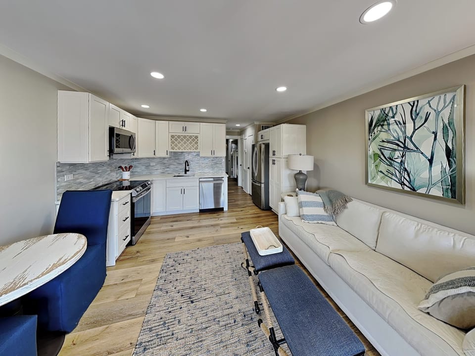 Step into the bright, airy living area with coastal decor, kick off your shoes, and relax into island time.