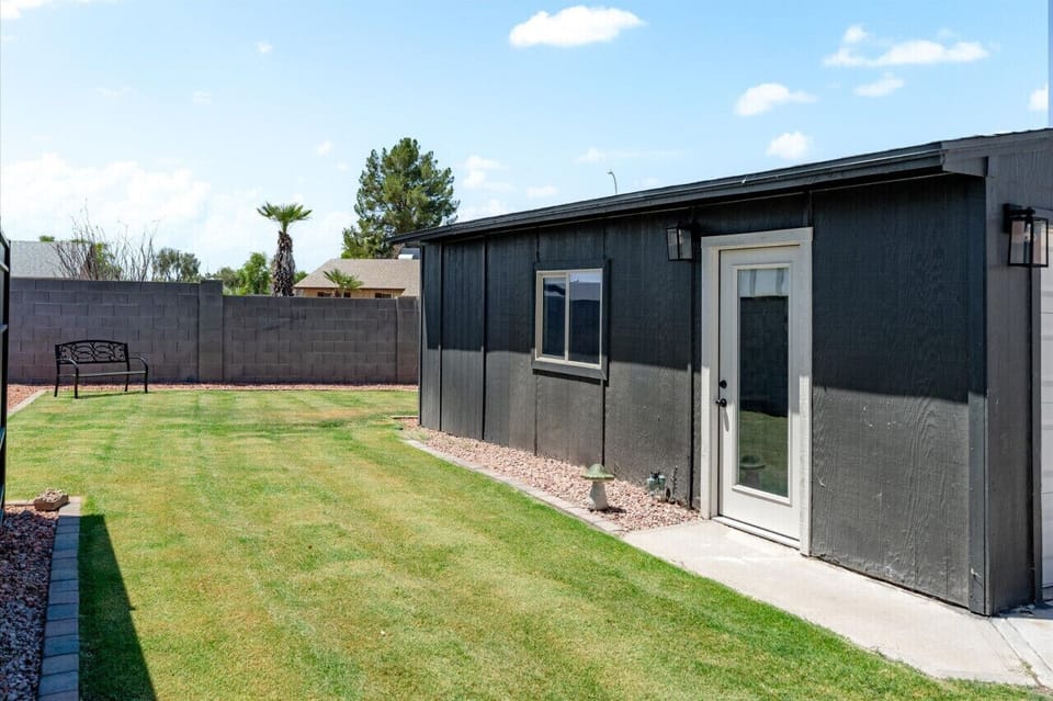 Spacious backyard with a well-maintained lawn and cozy outdoor seating.