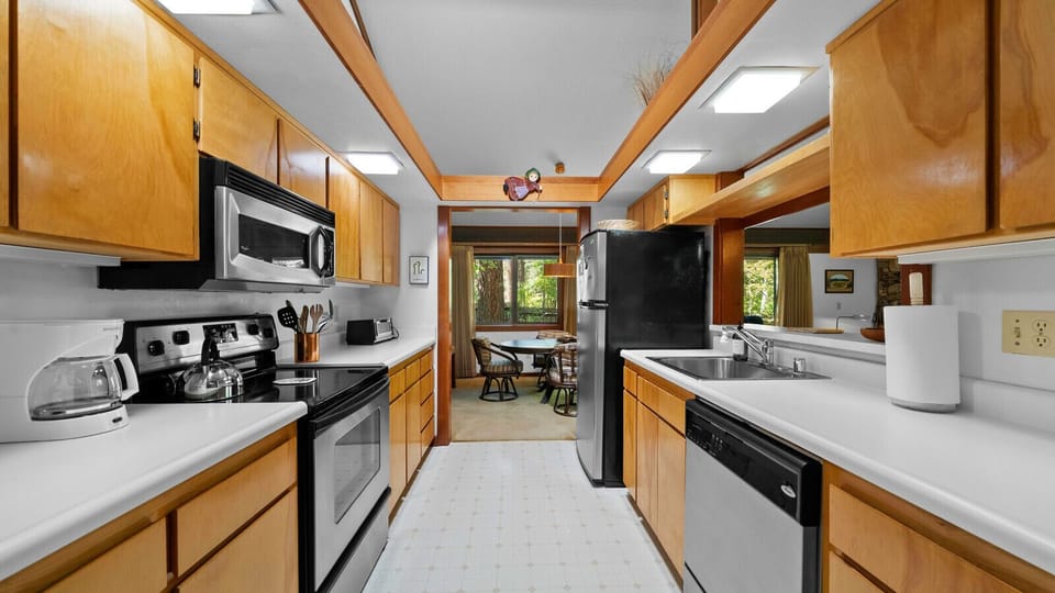 Galley kitchen with passthrough to living and opens to dining