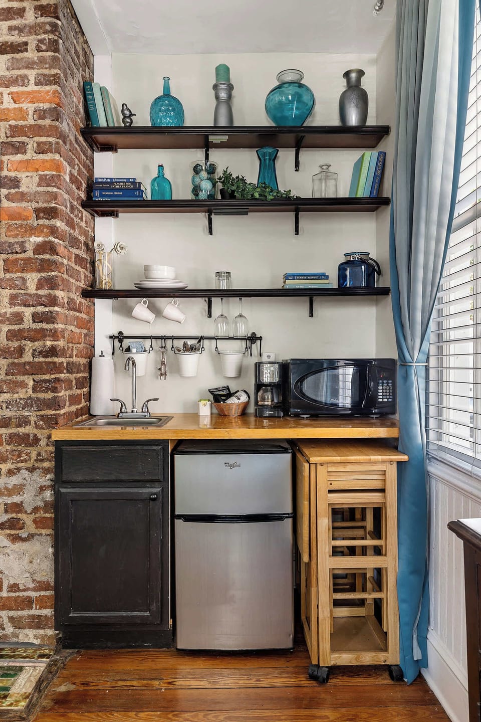 Enjoy meals at the cozy dining nook surrounded by exposed brick and soft lighting.
