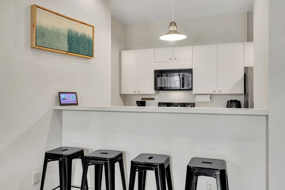 Bright kitchen with bar seating.