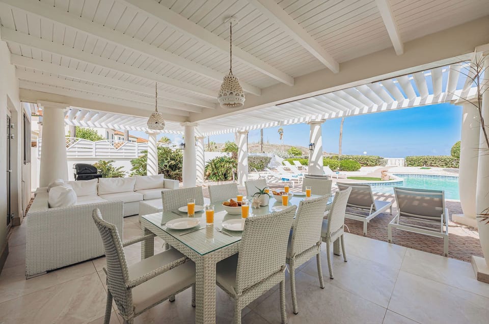Covered patio dining overlooking the pool area