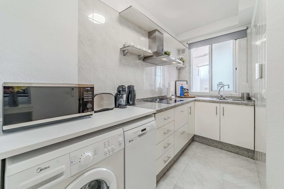 Fully Equipped Kitchen with Fridge, Dishwasher, Washing Machine, Coffee Maker & More. 
