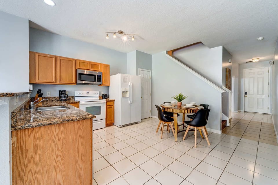 Modern kitchen with granite countertops and a cozy dining area for family meals.