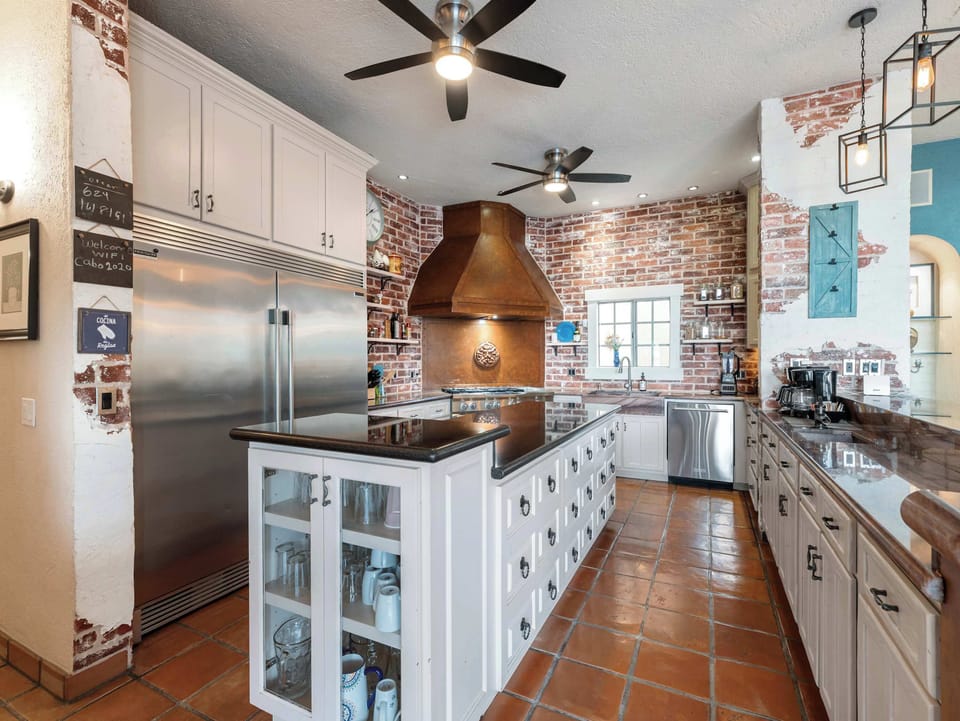 Chef-style kitchen gleaming w/ pro-grade appliances ready for big cooks.