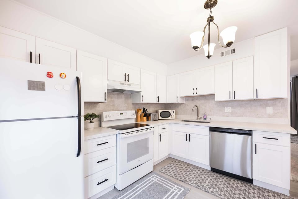 Prepare your favorite meals in this bright and modern kitchen, complete with state-of-the-art appliances, and ample natural light