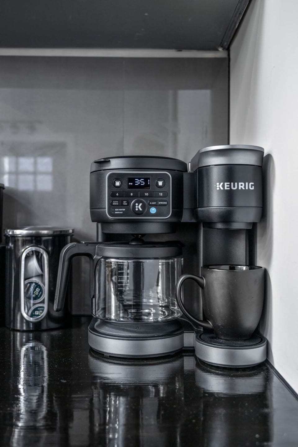 Keurig with pods and ground coffee, plus sugar, stevia, creamers—and a kettle with tea packets for the tea lovers!