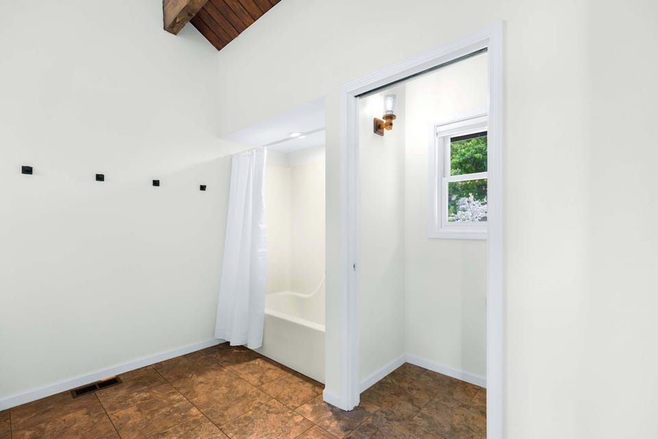 Spacious shared bathroom with single vanity & extra-large countertop