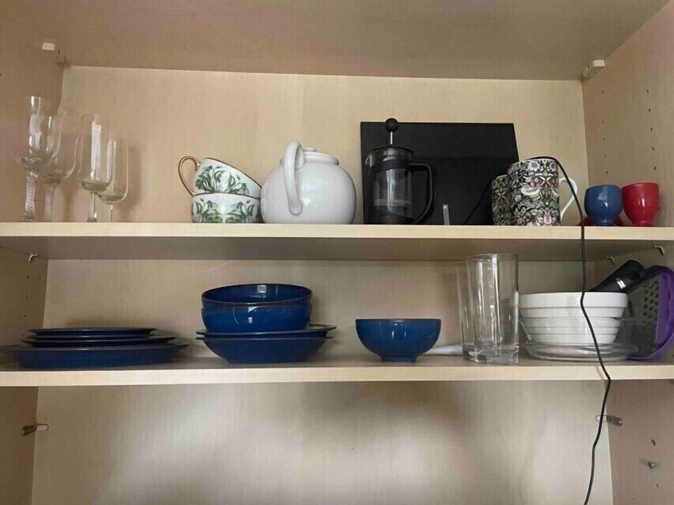Various sized plates and bowls, cutlery, cooking dishes, glasses, teapot, cafetière 