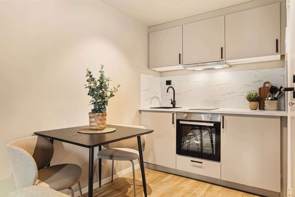 Prepare meals easily in a sleek kitchen with a dining nook perfect for two.