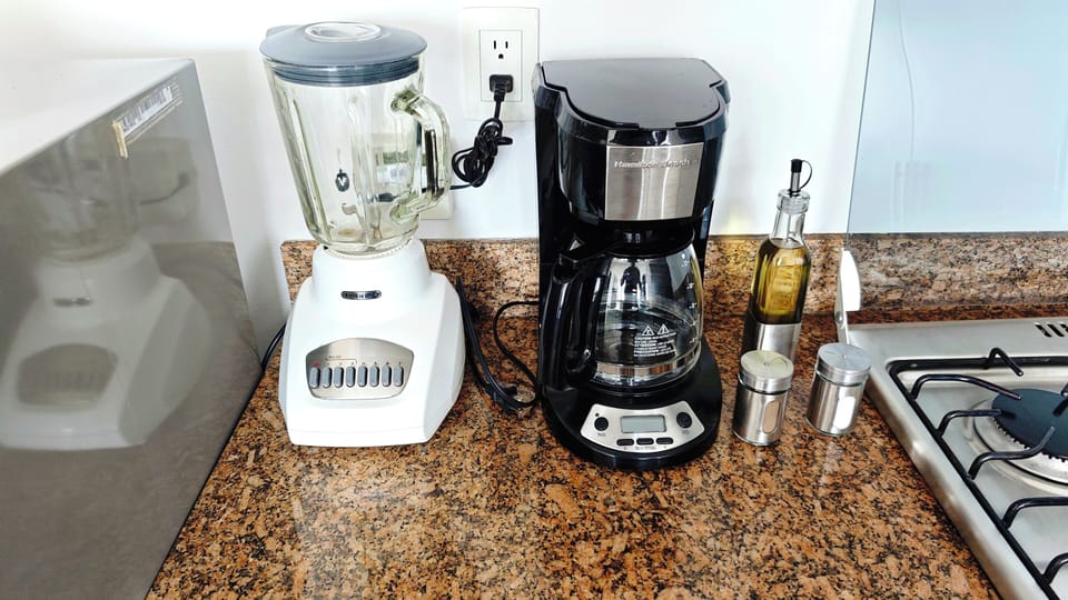 Bright eat-in kitchen with high-end appliances, fully equipped for home-cooked meals and morning coffee. Stylish, functional, and perfect for dining in.
