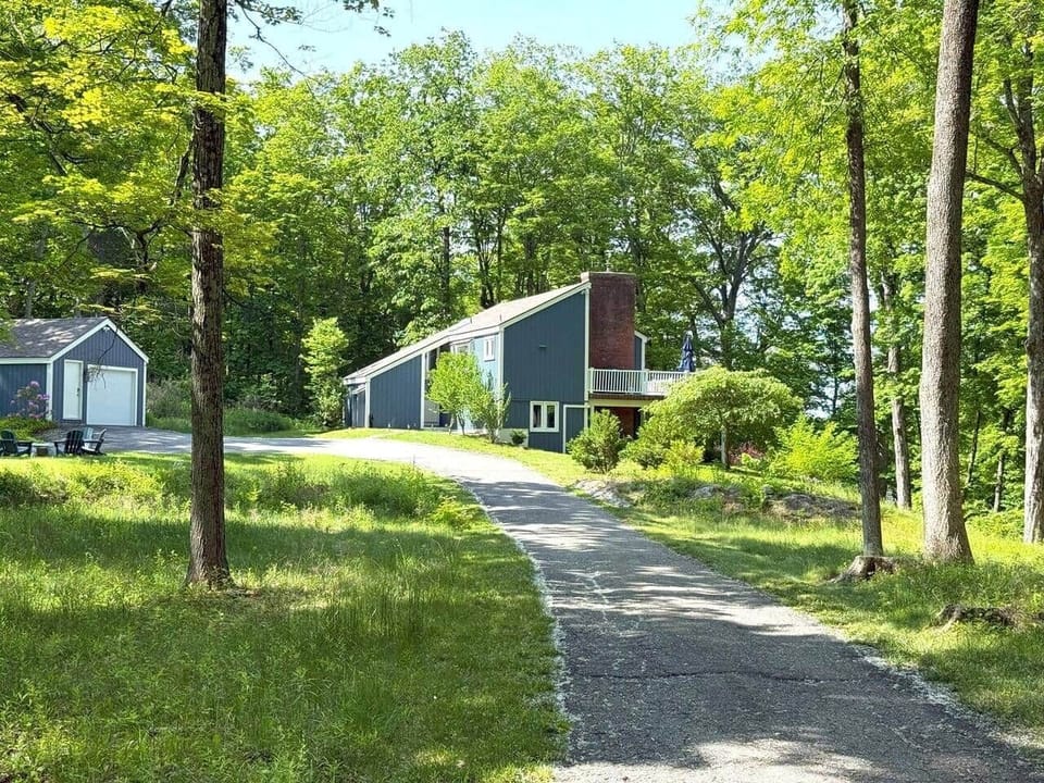 Our home and garage, nestled among lush greenery, welcome you from the private drive. Enjoy peaceful surroundings, natural light, and easy access to the lake for relaxation or adventure. A cozy retreat perfect for making memories in Connecticut.