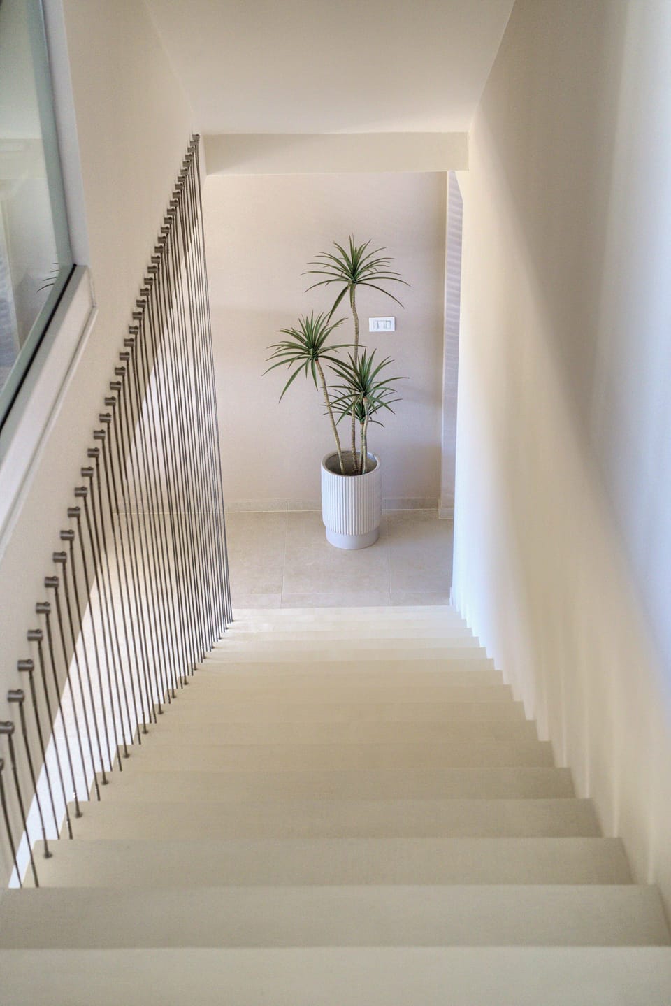 Clean Japandi staircase — soft light leads to 2 quiet bedrooms upstairs