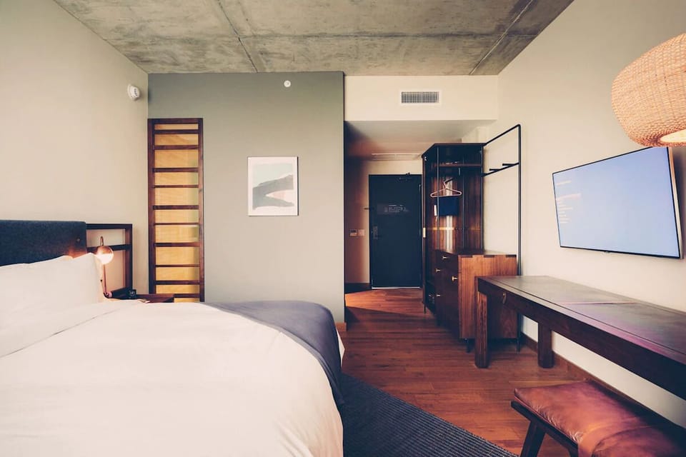 Relax after adventures in a sleek room with warm wood tones.
