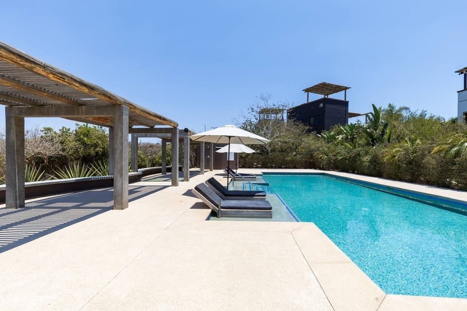 Community pool with loungers and gathering space. 