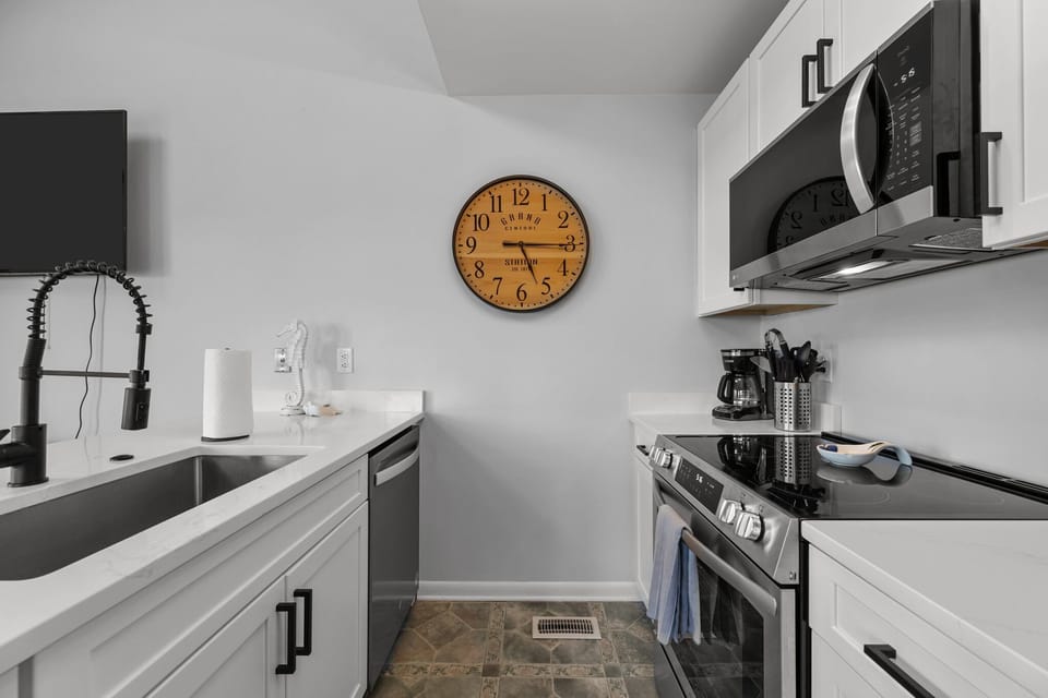 Bright, open white kitchen with clean lines and modern touches.