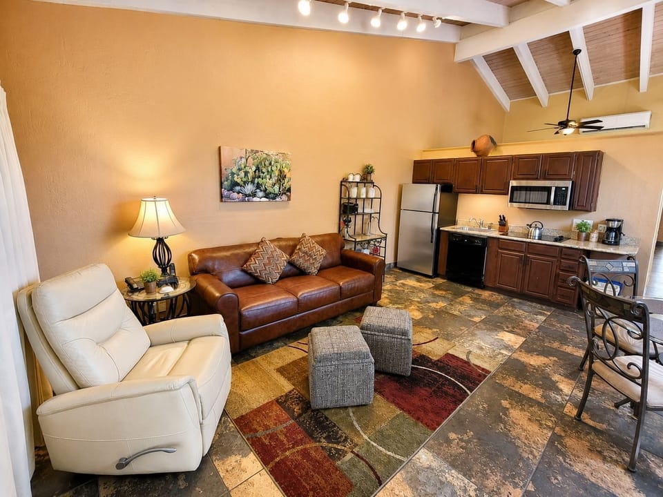 An inviting interior featuring a cozy living space and partial kitchen, ideal for relaxation and family gatherings after a day of exploring Sedona.