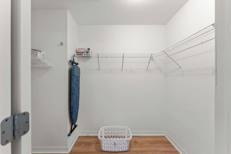 Large walk in closet with iron and ironing board for your convenience.