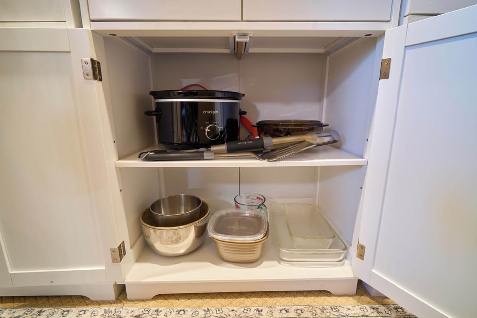 Crockpot, bowls, BBQ utensils and Pyrex glass baking dishes