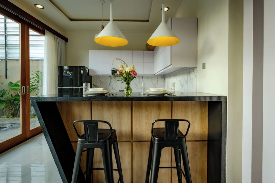 Fully equipped kitchen and dining table at Vil’latu Ubud