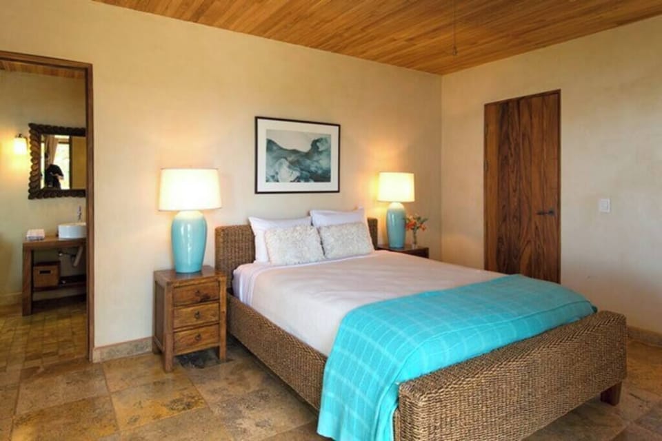 Charming queen-size suite with elegant furnishings and soothing decor, offering a comfortable and peaceful retreat for your Tamarindo vacation stay.