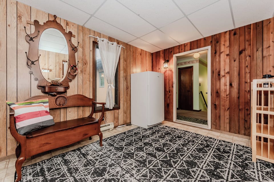 This convenient entry area includes coat hooks, bench seating, and an extra freezer for longer stays or storing your fresh market finds.