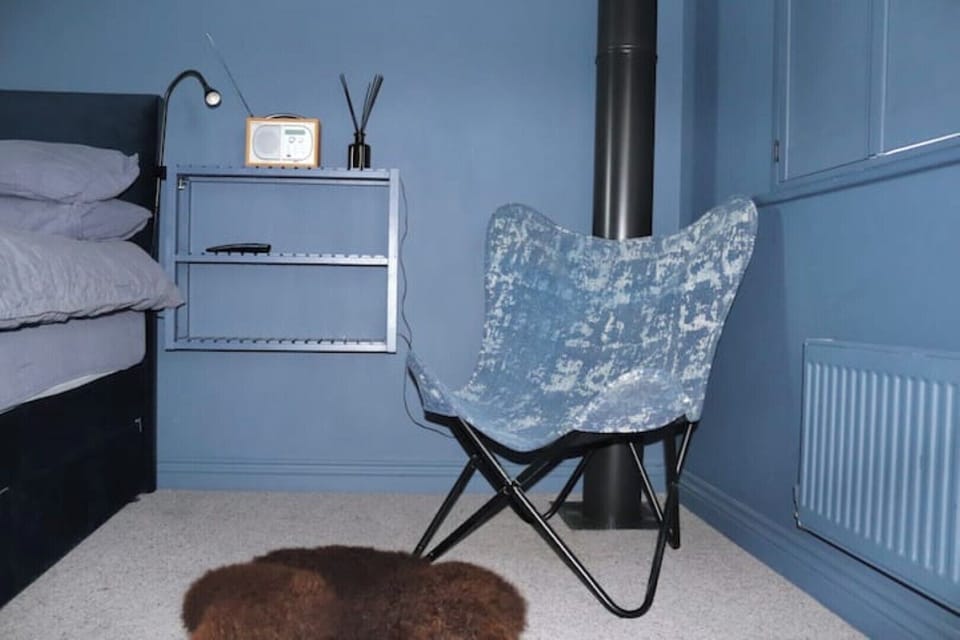 Blue bedroom. The digital radio and the hairdryer live here