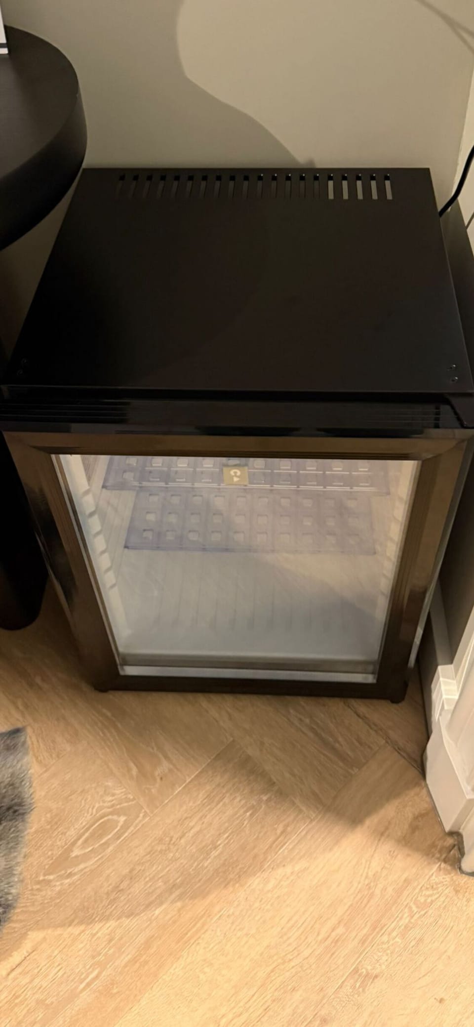 Mini fridge with glass door — ideal for cooling your favorite drinks or storing small bites for later.