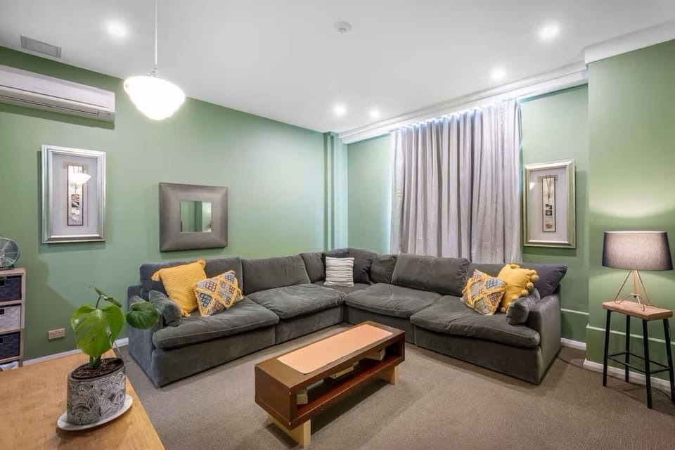 Unwind in the cosy living area with an oversized L-shaped sofa and a TV—perfect for relaxing after exploring Hobart’s cultural gems.