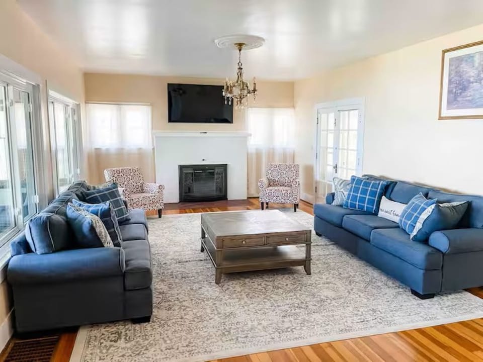 Bright lake-facing living room adjacent to the dining room